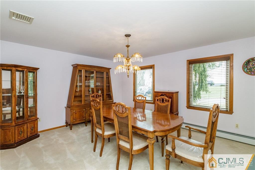 17 Garden Street East Hanover, NJ 07936 - Photo 6 of 34 a view of a dining room with furniture and chandelier