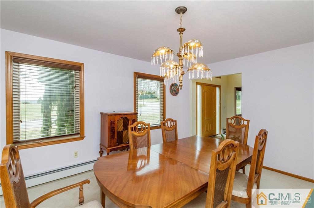 17 Garden Street East Hanover, NJ 07936 - Photo 7 of 34 a dining room with furniture a chandelier and window