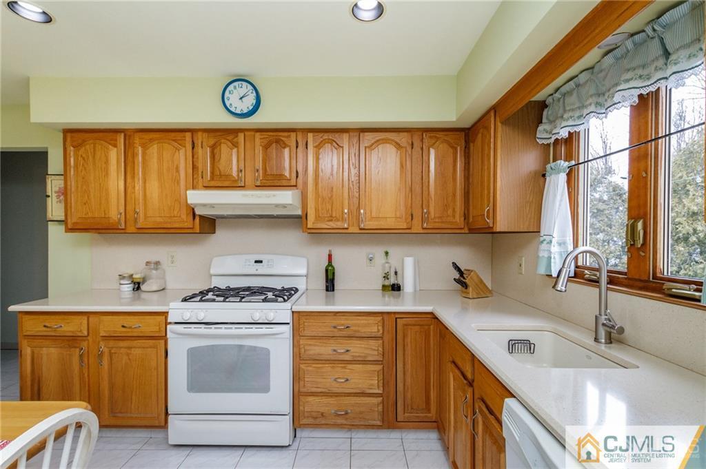 17 Garden Street East Hanover, NJ 07936 - Photo 10 of 34 a kitchen with granite countertop a sink cabinets stainless steel appliances and a window