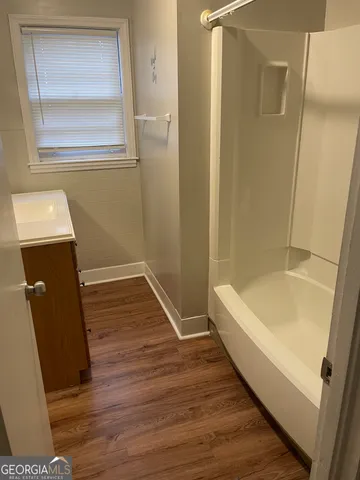 a bathroom with a bathtub and shower