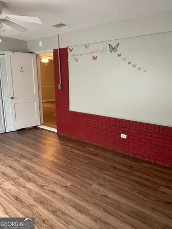 a view of a room with wooden floor and window