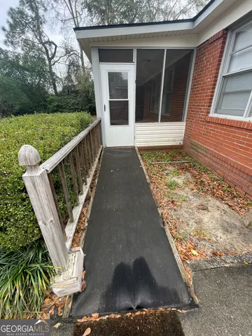 a view of a balcony with wooden floor and fence