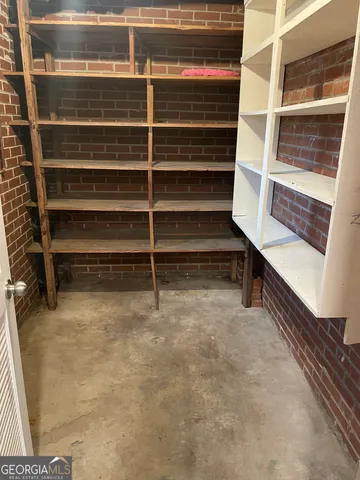 a view of an empty room with empty shelves