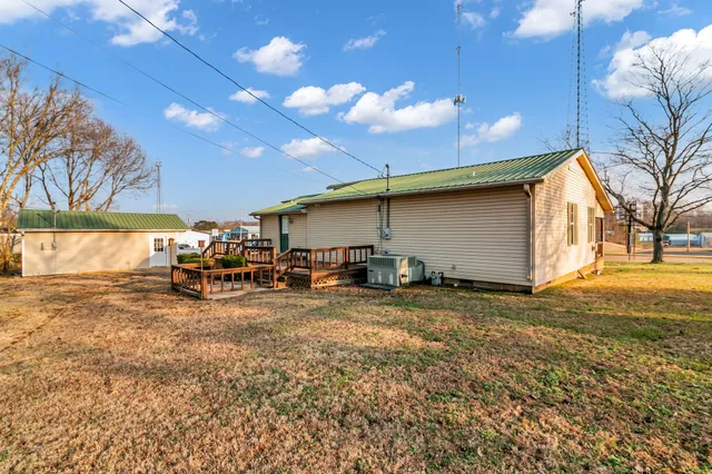 a view of a yard with table and chairs under an umbrella