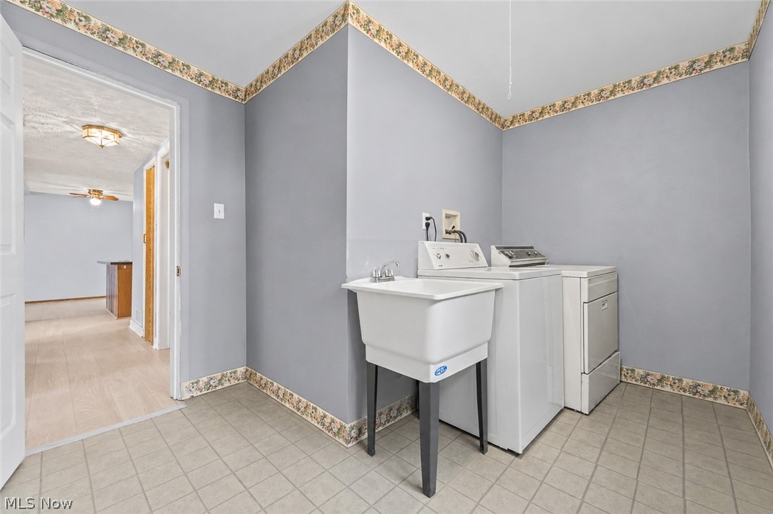 150 Graham Road Cuyahoga Falls, OH 44223 - Photo 24 of 38 Dedicated laundry area featuring a utility sink and tiled flooring