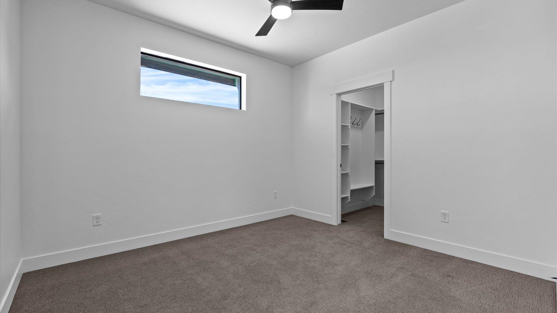 2045 Caleb Street Grand Junction, CO 81507 - Photo 31 of 42 an empty room with a ceiling fan and window