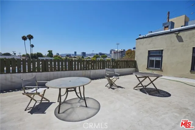 a view of a patio with a table and chairs