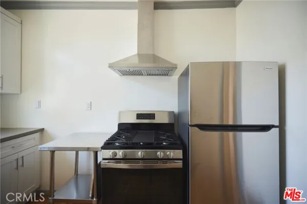 a kitchen with a stove and a refrigerator