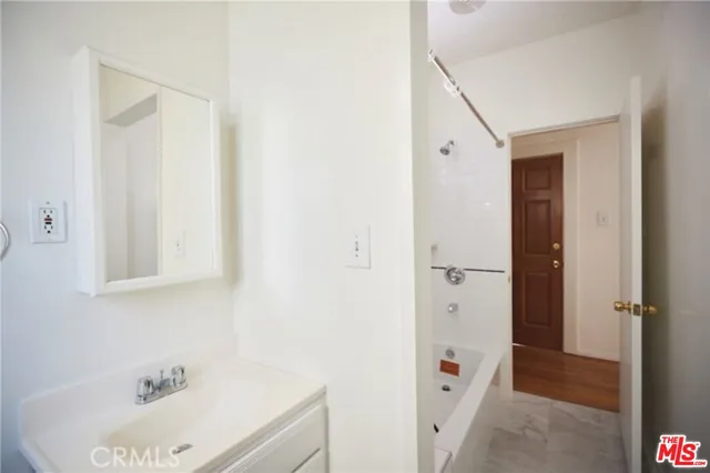 a bathroom with a tub and sink