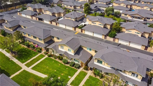 an aerial view of a house with a garden and trees