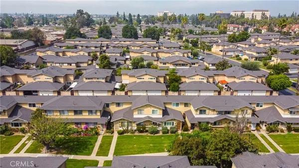an aerial view of residential houses with outdoor space and street view