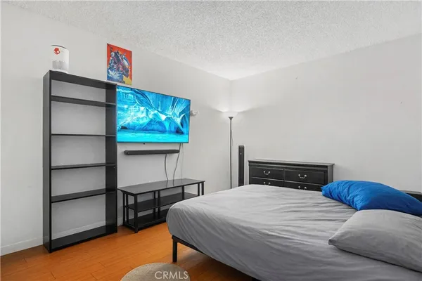 a bedroom with a bed and a flat screen tv