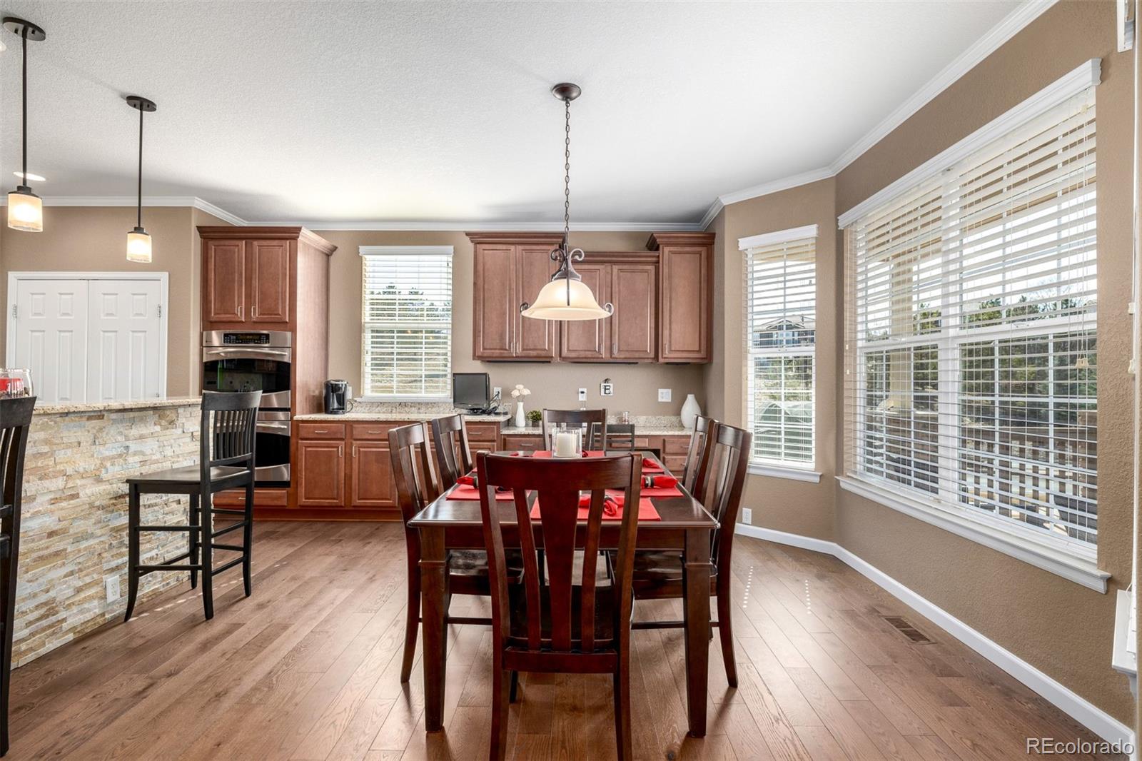3422 Vestal Loop Broomfield, CO 80023 - Photo 13 of 50 a view of a dining room with furniture window and wooden floor