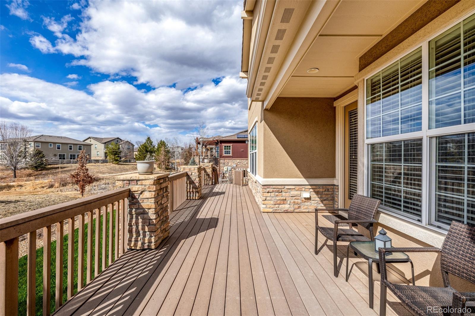 3422 Vestal Loop Broomfield, CO 80023 - Photo 34 of 50 a view of a balcony with wooden floor and outdoor seating