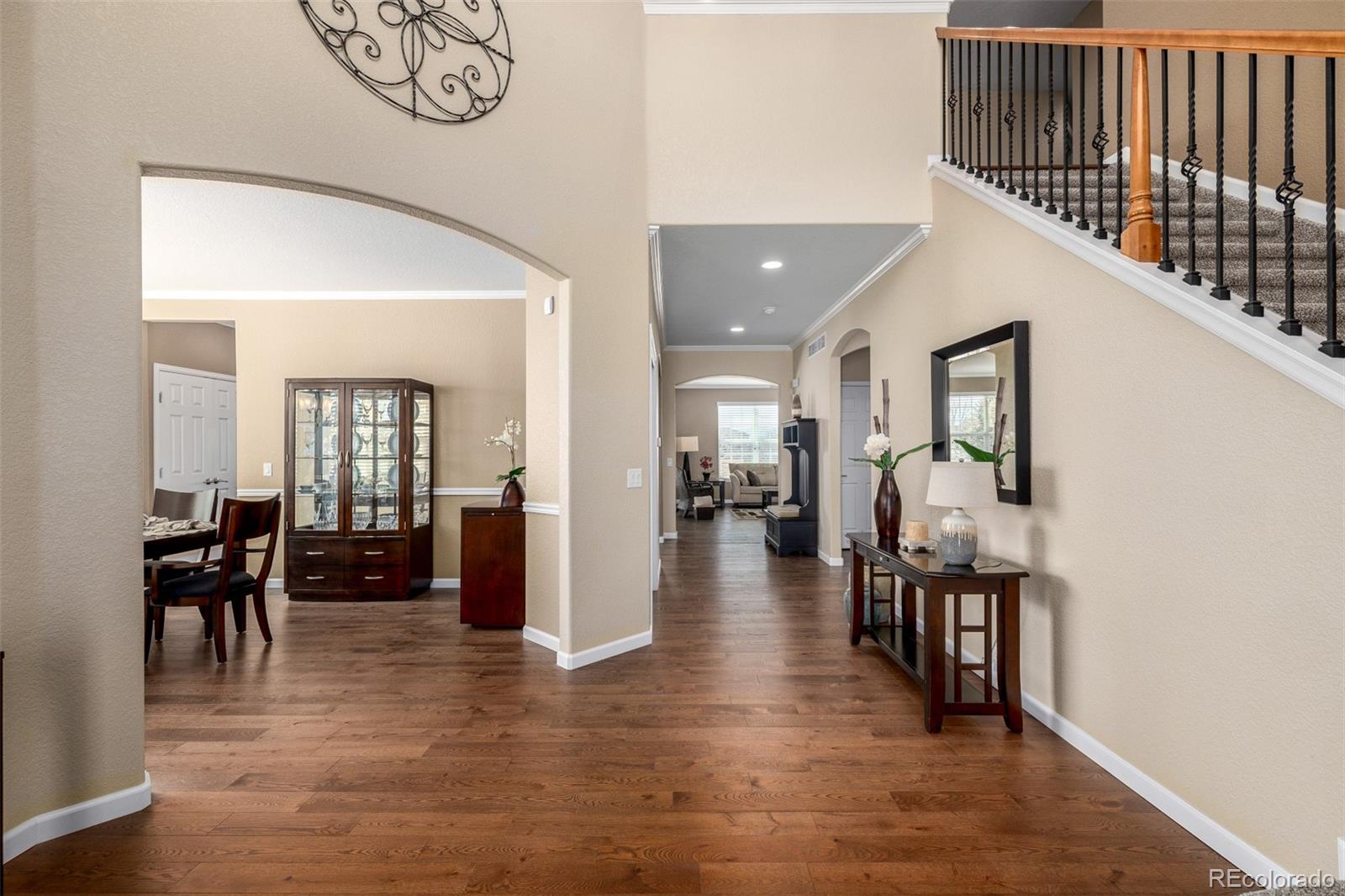3422 Vestal Loop Broomfield, CO 80023 - Photo 8 of 50 a hallway with wooden floor and furniture