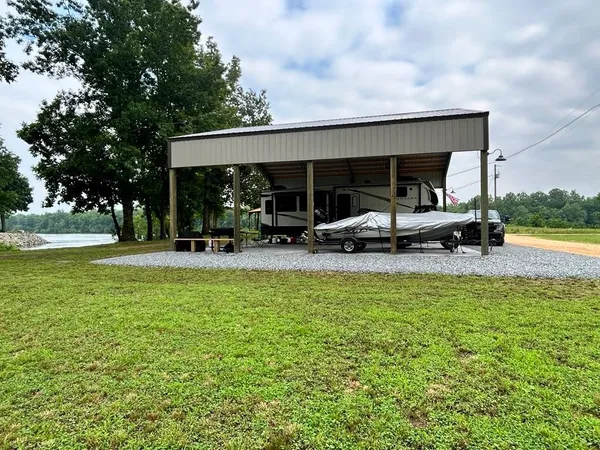 a view of a swimming pool with lawn chairs and a big yard