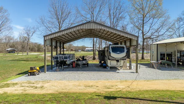 a view of a house with a yard balcony and sitting area