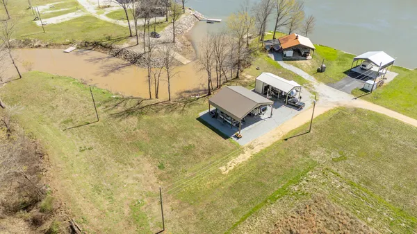 a view of a house with backyard and a tree