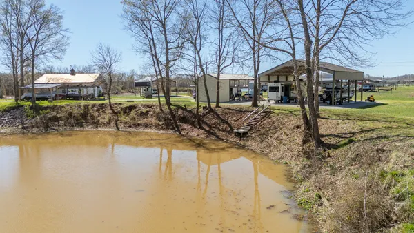 an aerial view of a house with a lake view