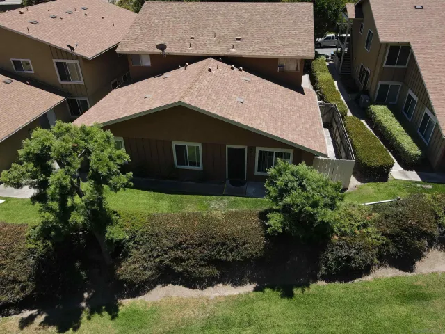 an aerial view of a house with a yard
