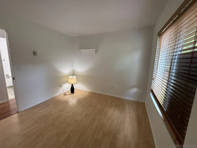 a room with wooden floor and a window