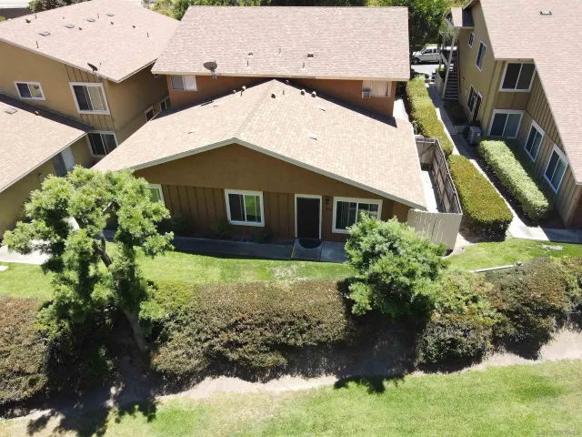 an aerial view of a house with a yard