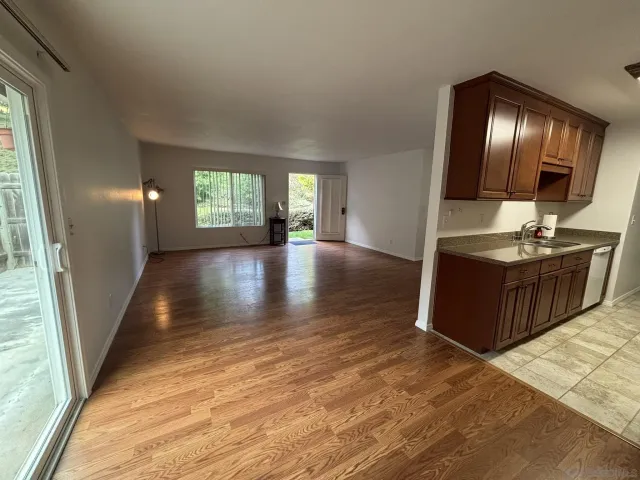 a view of a hallway with wooden floor and stairs