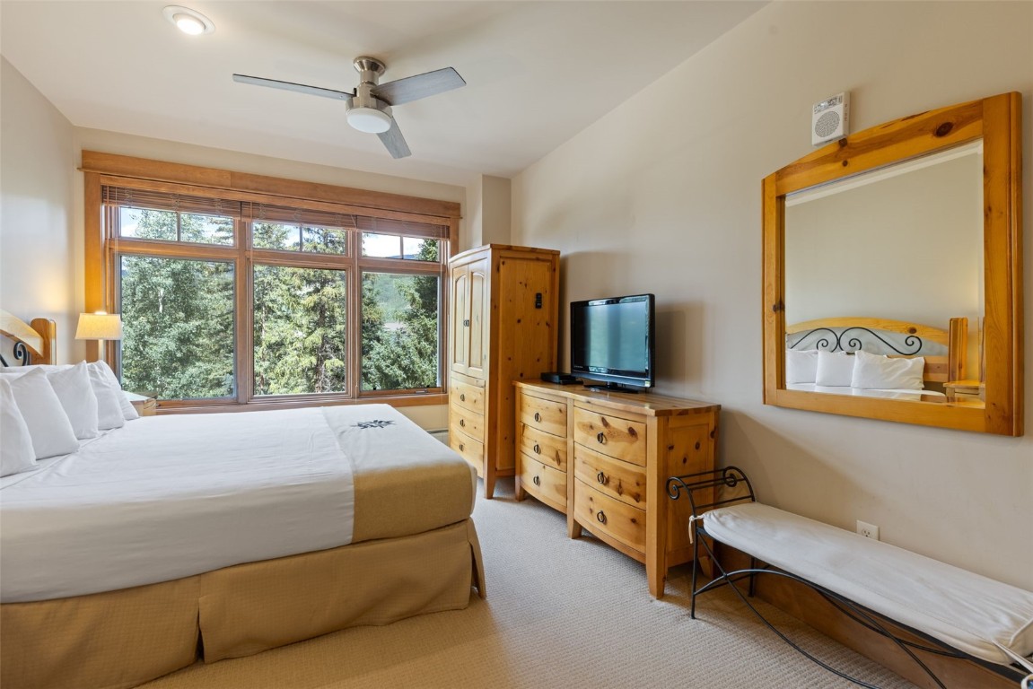 280 Trailhead Drive, Unit 3027 Keystone, CO 80435 - Photo 27 of 50 a room with a bed and a flat tv screen on dresser