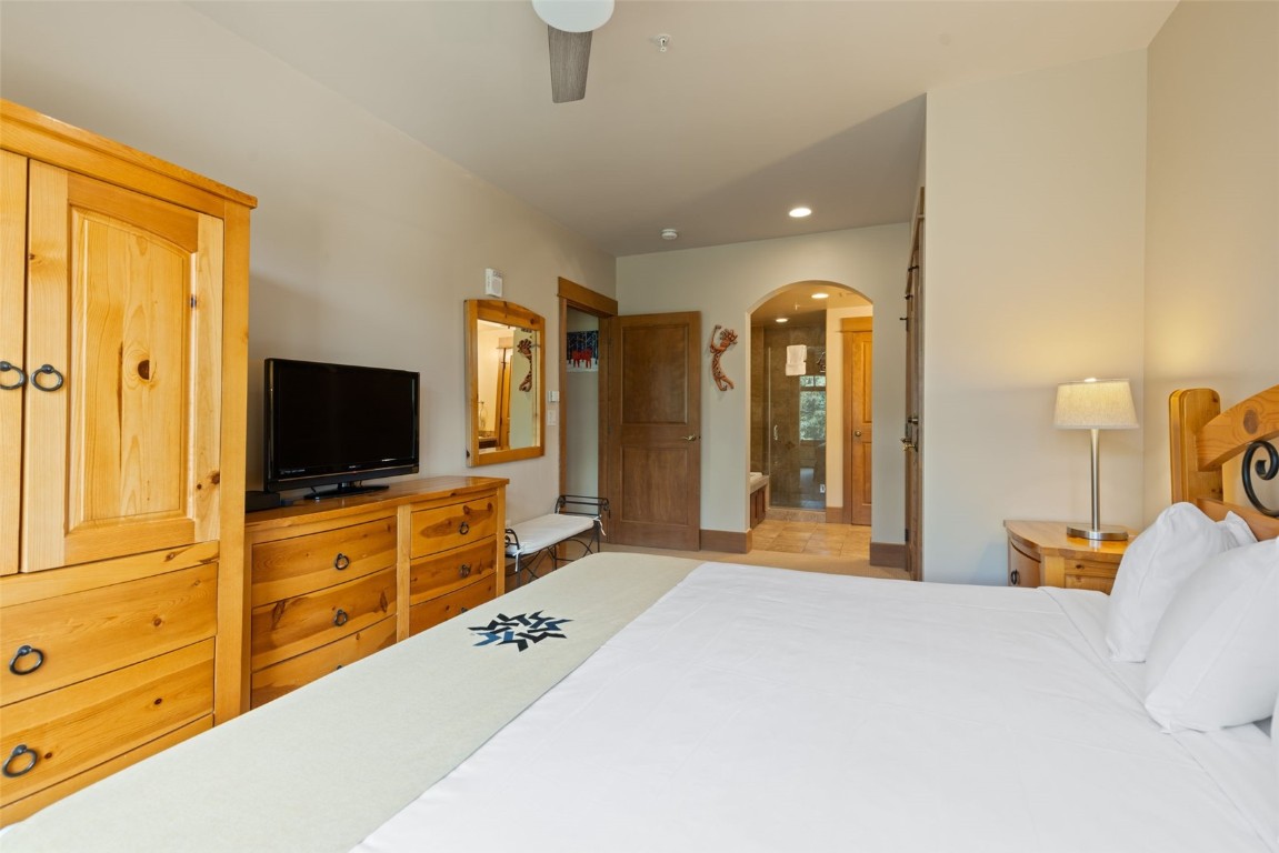 280 Trailhead Drive, Unit 3027 Keystone, CO 80435 - Photo 28 of 50 a bedroom with a bed and a flat screen tv in it