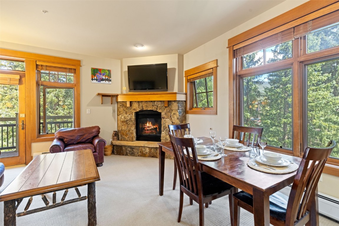 280 Trailhead Drive, Unit 3027 Keystone, CO 80435 - Photo 7 of 50 a dining room with furniture a fireplace and wooden floor