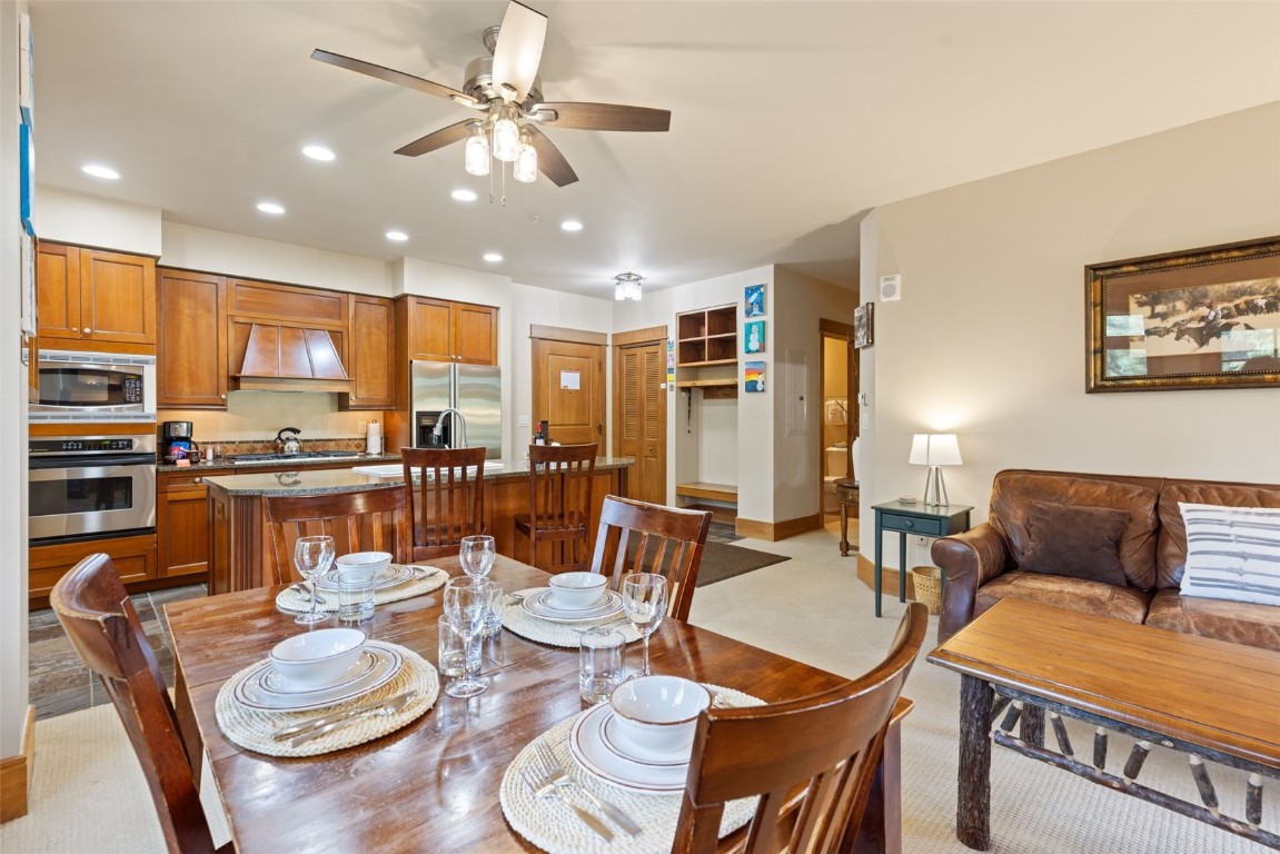 280 Trailhead Drive, Unit 3027 Keystone, CO 80435 - Photo 9 of 50 a dining room with furniture a rug and kitchen view