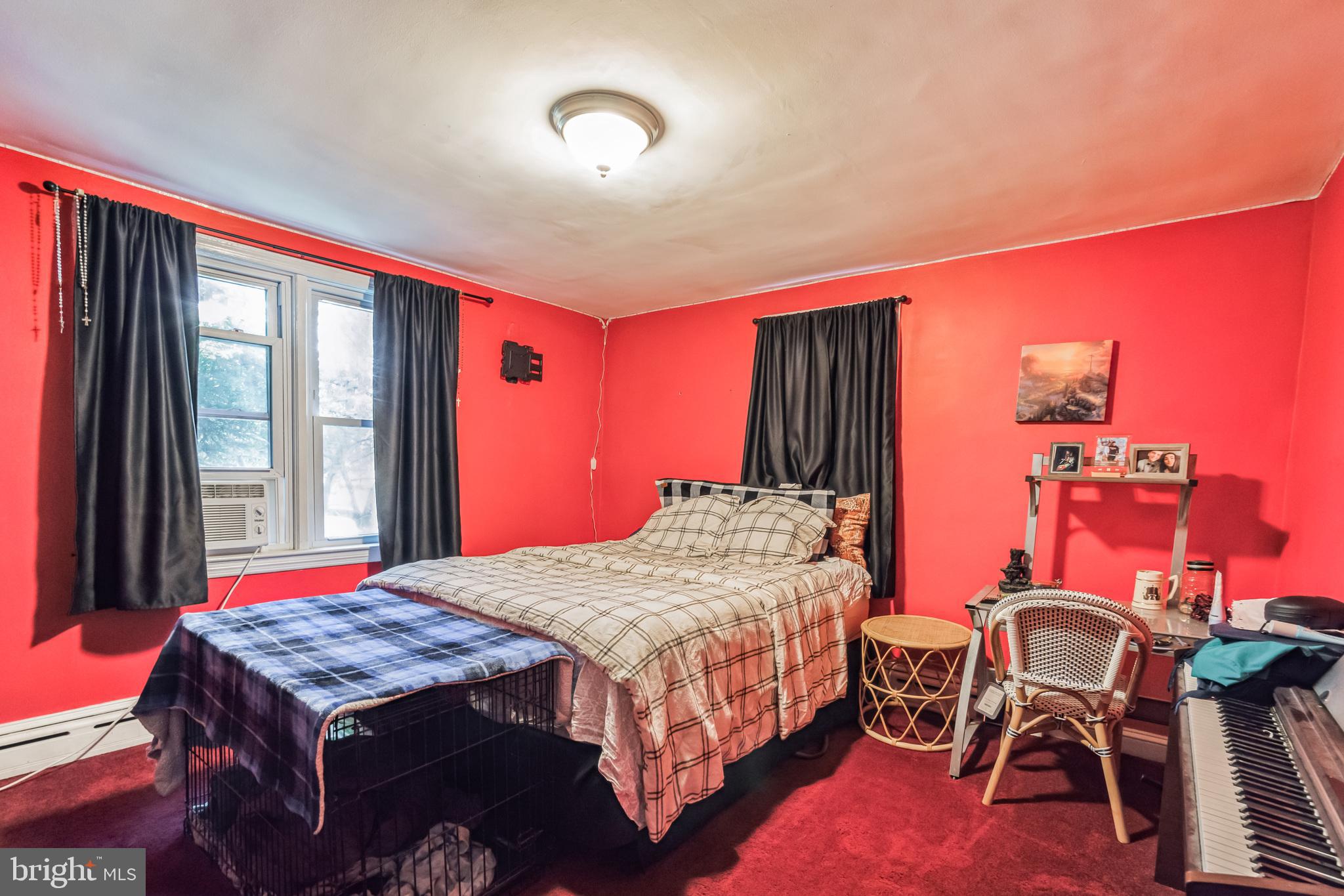 1443 Rhawn Street Philadelphia, PA 19111 - Photo 21 of 45 a bedroom with a bed and a table in it