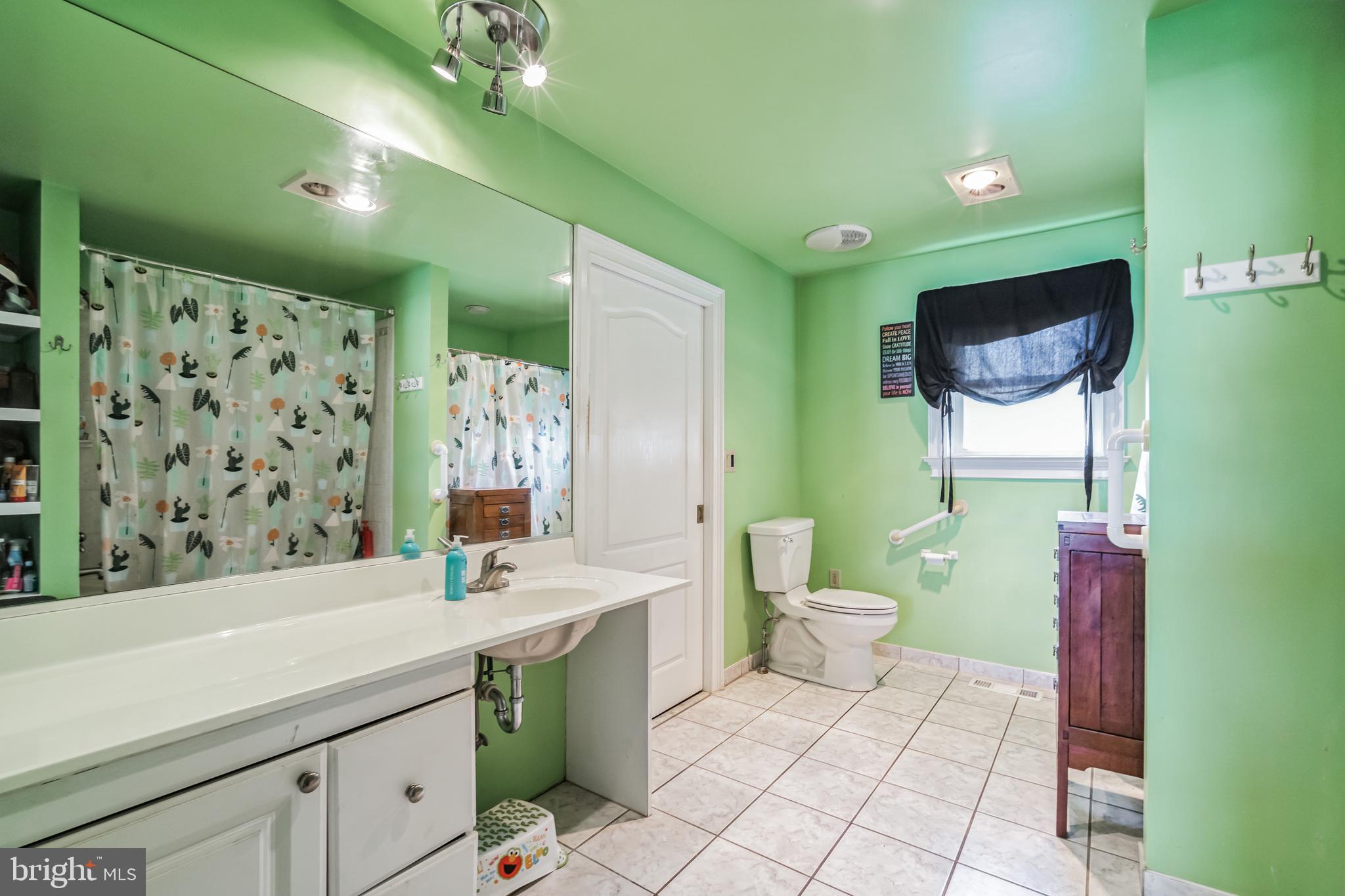 1443 Rhawn Street Philadelphia, PA 19111 - Photo 24 of 45 a bathroom with a sink a toilet and mirror
