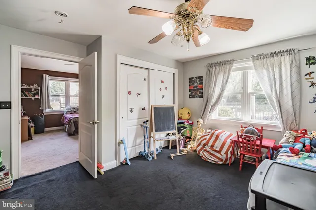a bedroom with furniture and a large window