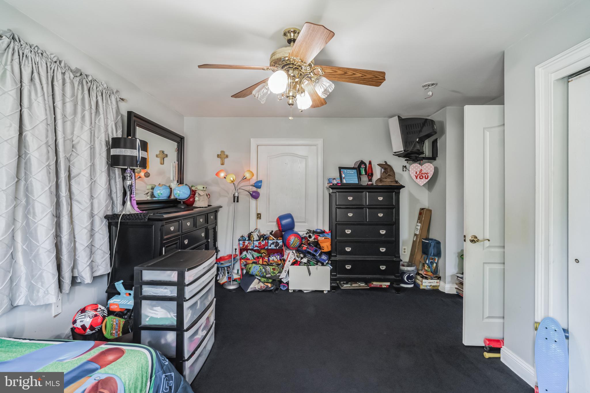 1443 Rhawn Street Philadelphia, PA 19111 - Photo 28 of 45 a bedroom with a bed closet and flat tv screen