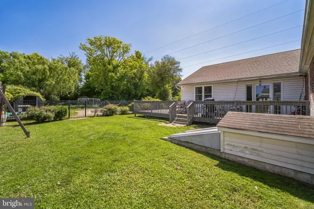 a view of a house with backyard and a tree