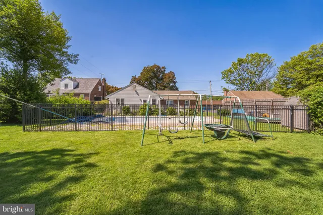 a view of a house with a backyard and a slide