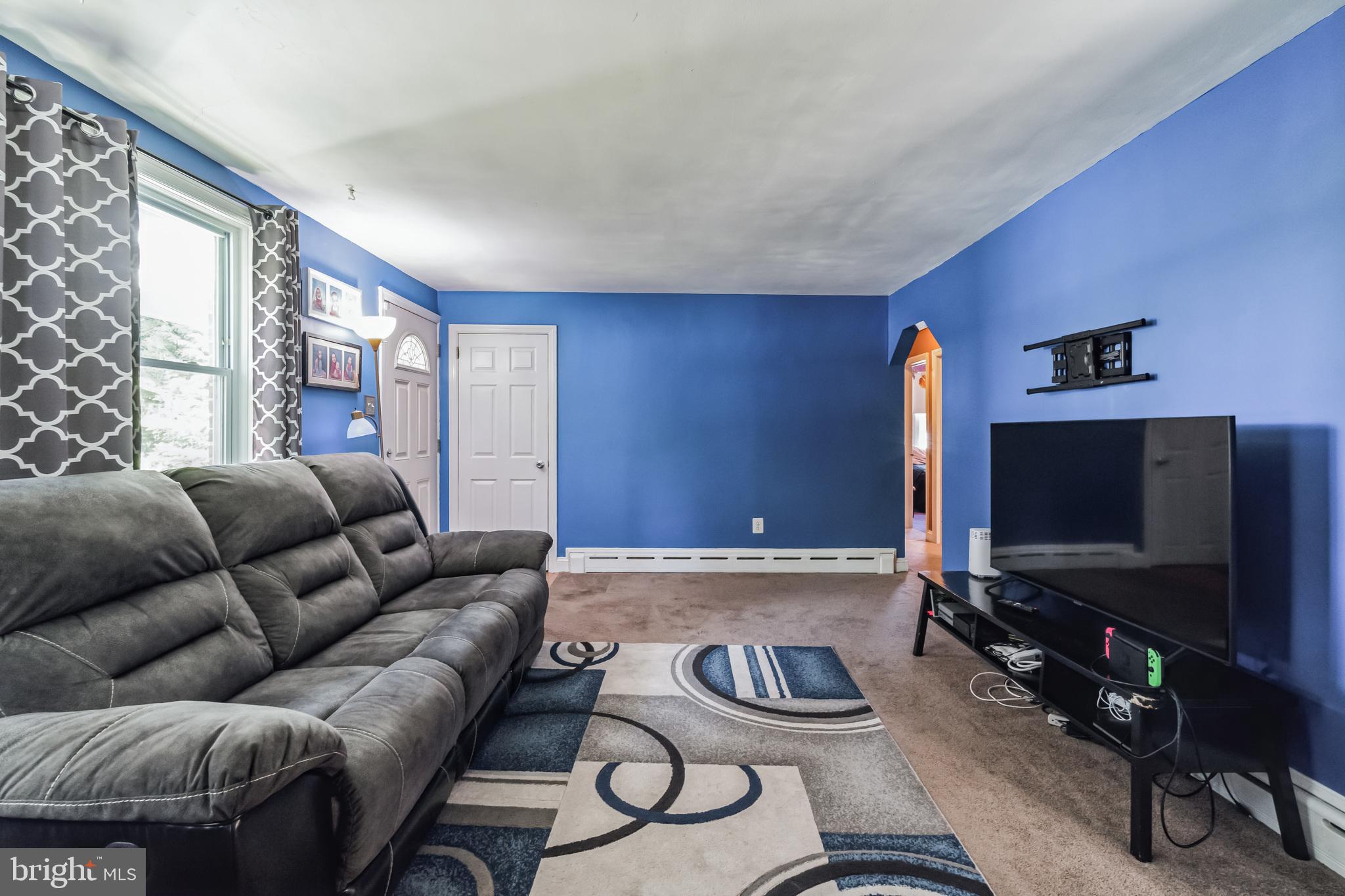 1443 Rhawn Street Philadelphia, PA 19111 - Photo 6 of 45 a living room with furniture and a flat screen tv