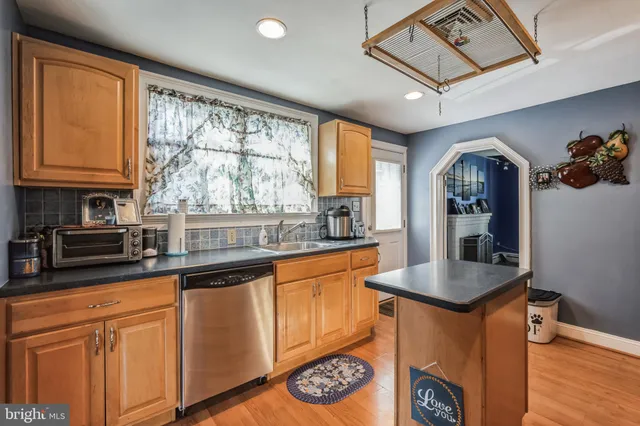 a kitchen with granite countertop a stove a sink and a granite counter top