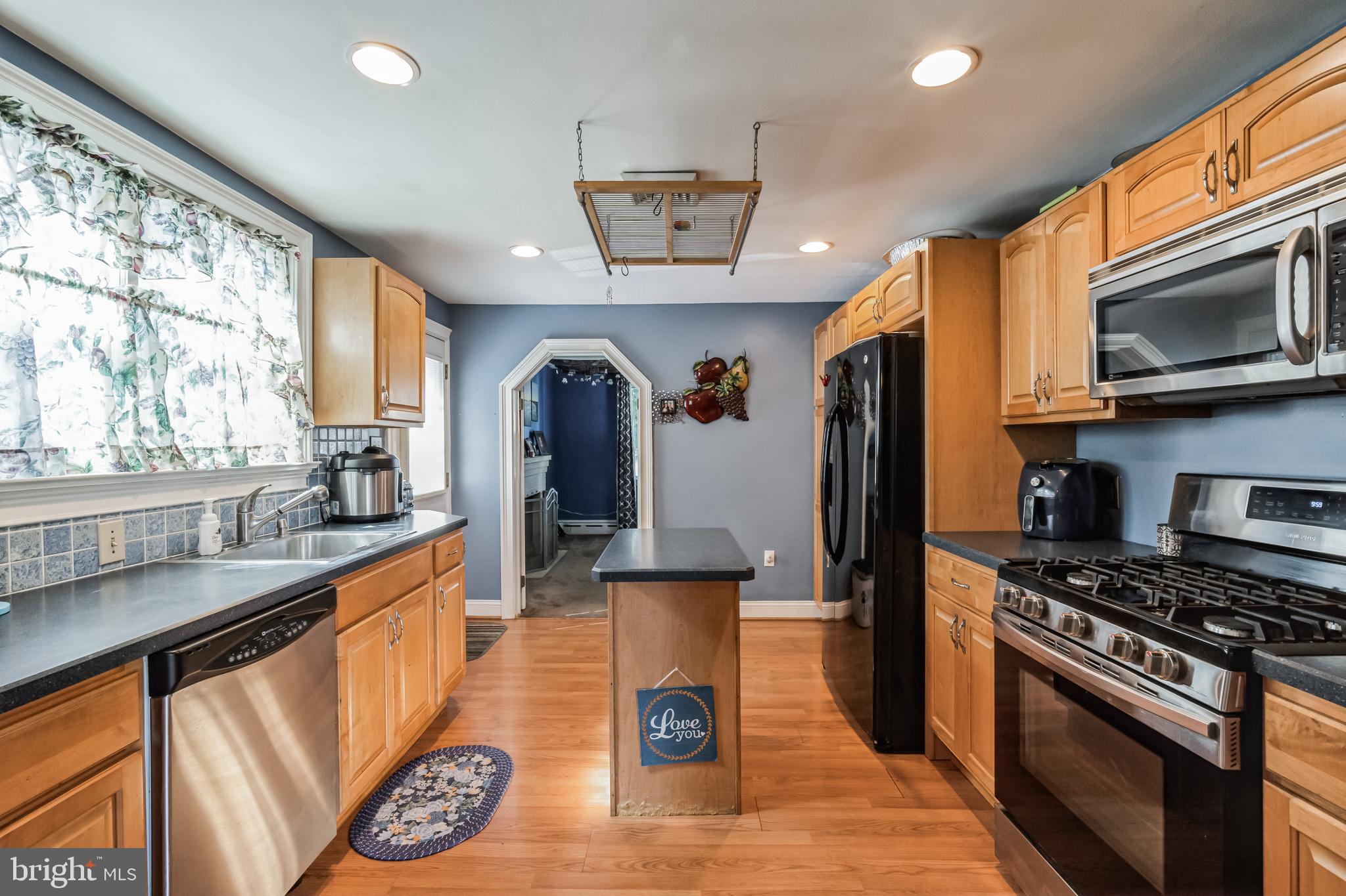1443 Rhawn Street Philadelphia, PA 19111 - Photo 8 of 45 a kitchen with stainless steel appliances granite countertop a stove a sink and a microwave