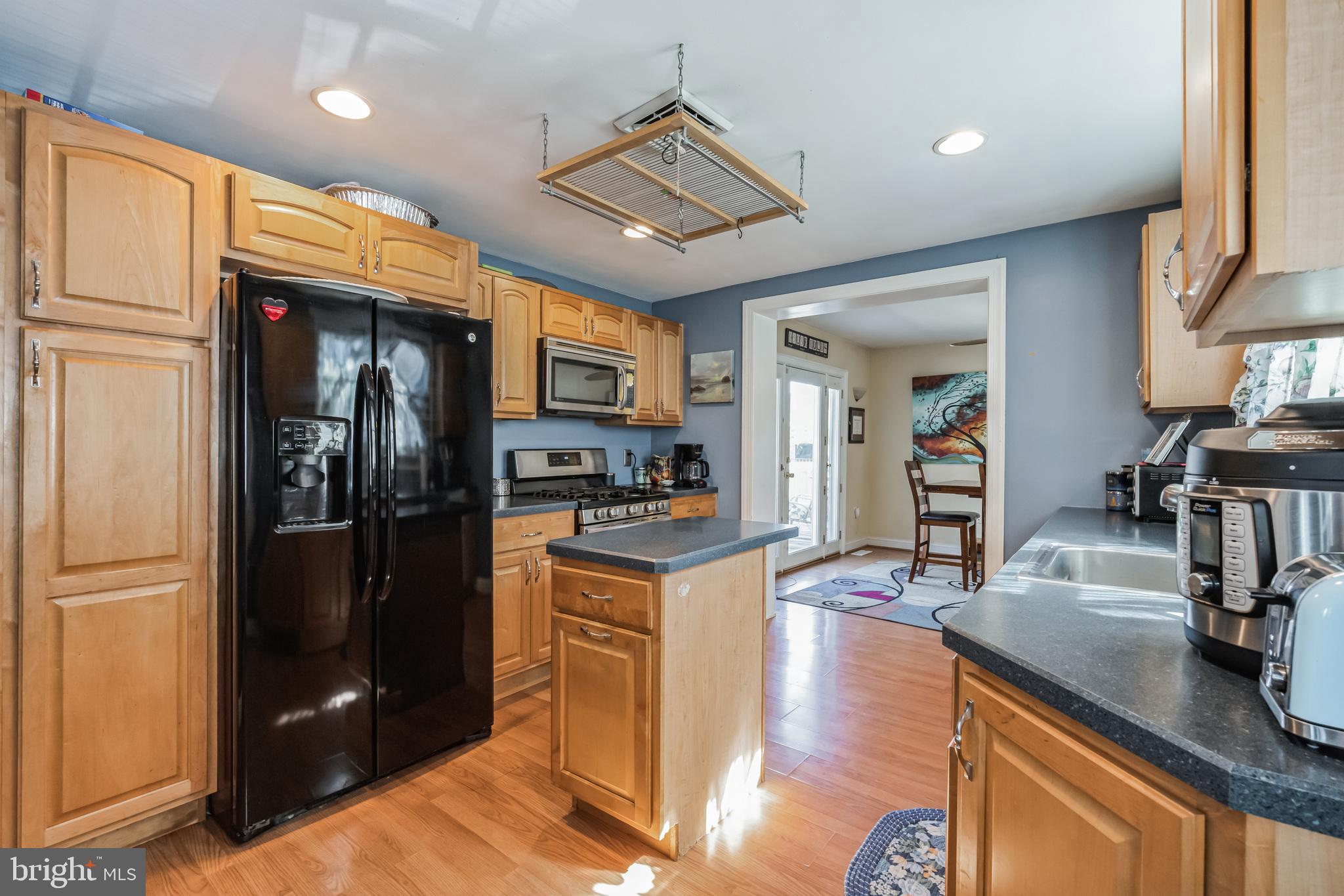1443 Rhawn Street Philadelphia, PA 19111 - Photo 9 of 45 a kitchen with stainless steel appliances granite countertop a refrigerator a stove and a sink with wooden floor