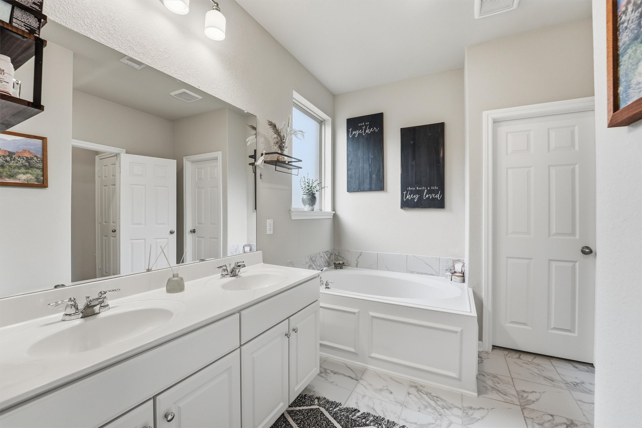 2130 Shellbark Way La Marque, TX 77568 - Photo 12 of 30 Primary bathroom features a double vanity with sleek sinks, a spacious garden tub and large closet.