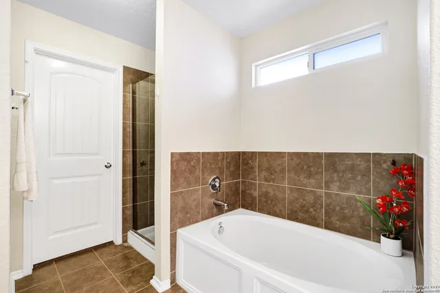 a bathroom with a bathtub and shower