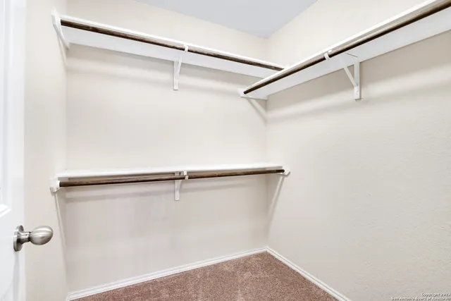 a view of a room with shelf on the wall