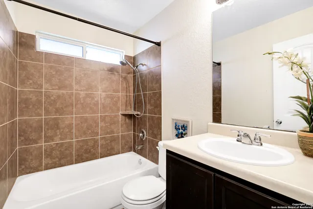 a bathroom with a sink a toilet and bathtub