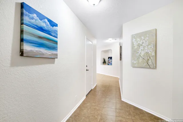 a view of a hallway with paintings on the wall