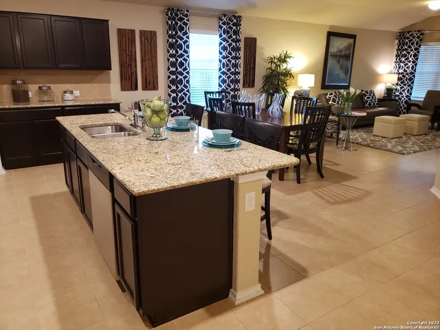 a kitchen with granite countertop a sink and a stove