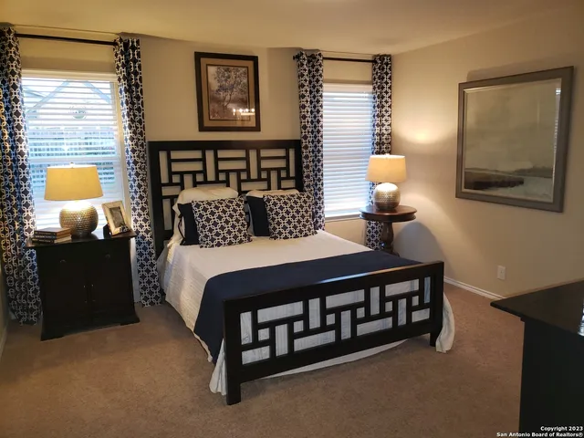 a bedroom with a bed and a lamp on table