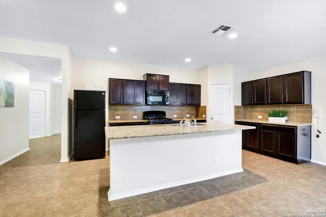 a large kitchen with stainless steel appliances lots of counter top space