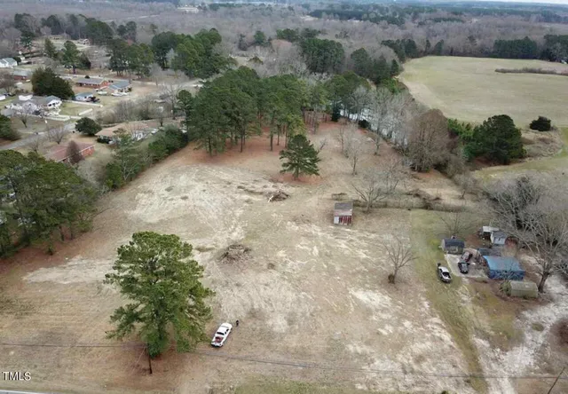 a view of a dry yard with trees